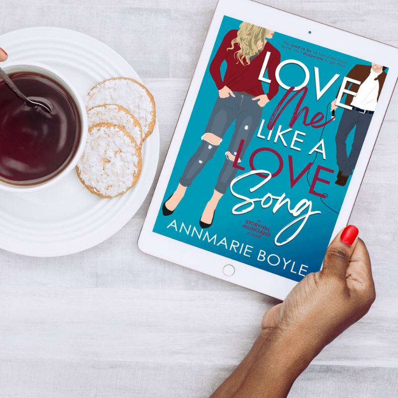 E-reader being held by a Black woman with the e-book cover of Love Me Like a Love Song, Book 1 in the Storyhill Musicians contemporary romance series.